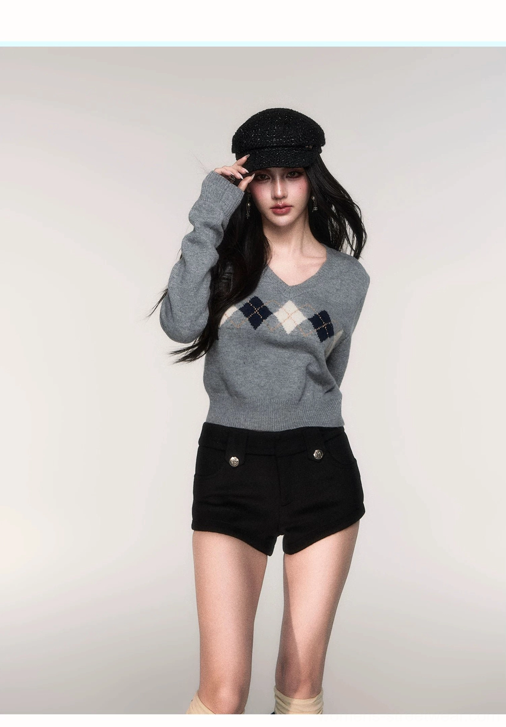 Women's preppy streetwear grey argyle cropped knit sweater with ribbed cuffs styled with black shorts and knee socks