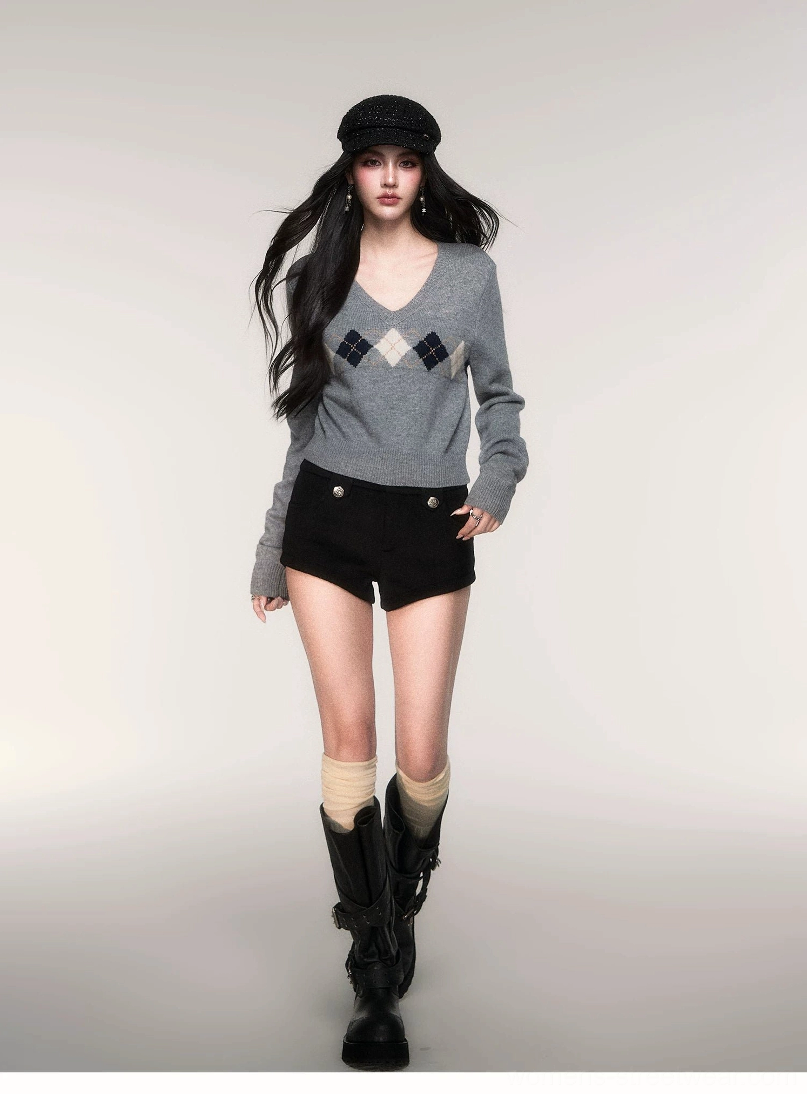 Women's grey argyle cropped V-neck sweater styled as Korean streetwear with combat boots knee socks and tailored shorts