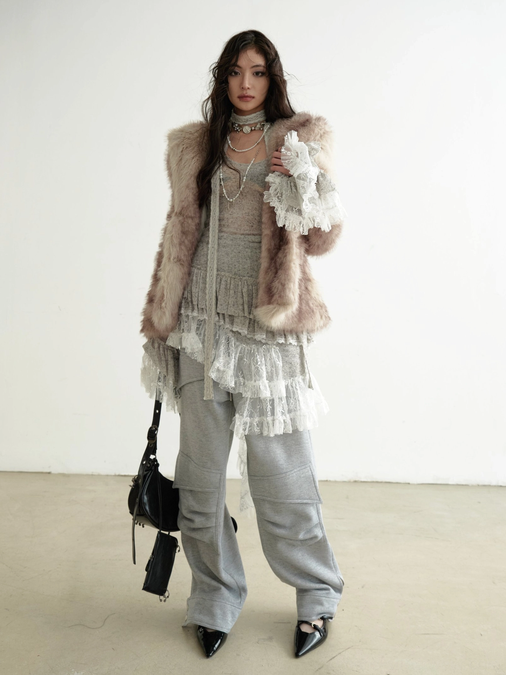 Grey asymmetrical lace panel knit dress with semi-sheer layered ruffle hem, long sleeves, and contemporary Seoul-inspired streetwear styling