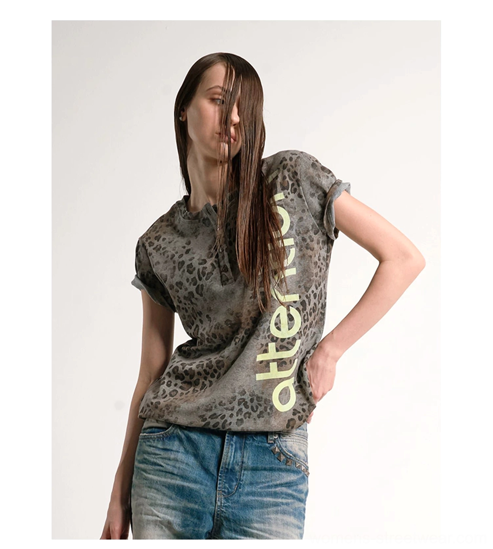Front medium view of a grey brown faded leopard Henley tee with vertical attention graphic styled with blue denim