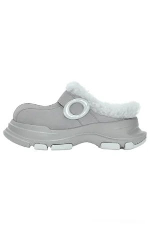 Grey faux fur lined platform clog slipper shown from the left side with matte suede-look upper, fluffy collar, circular ring strap detail, and chunky rubber outsole