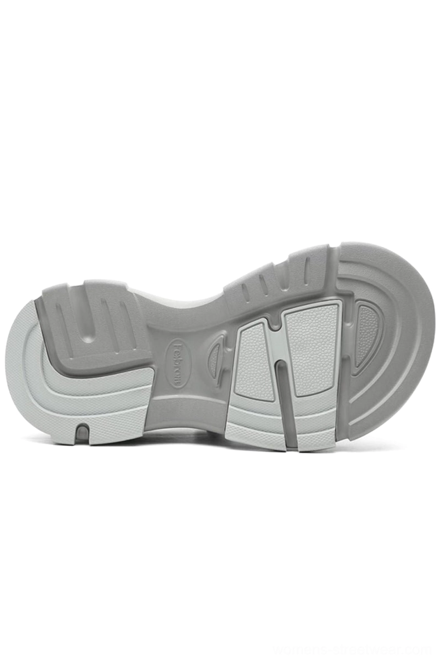 Bottom view of grey faux fur lined platform clog showing segmented anti-slip tread pattern and thick two-tone grey rubber platform sole