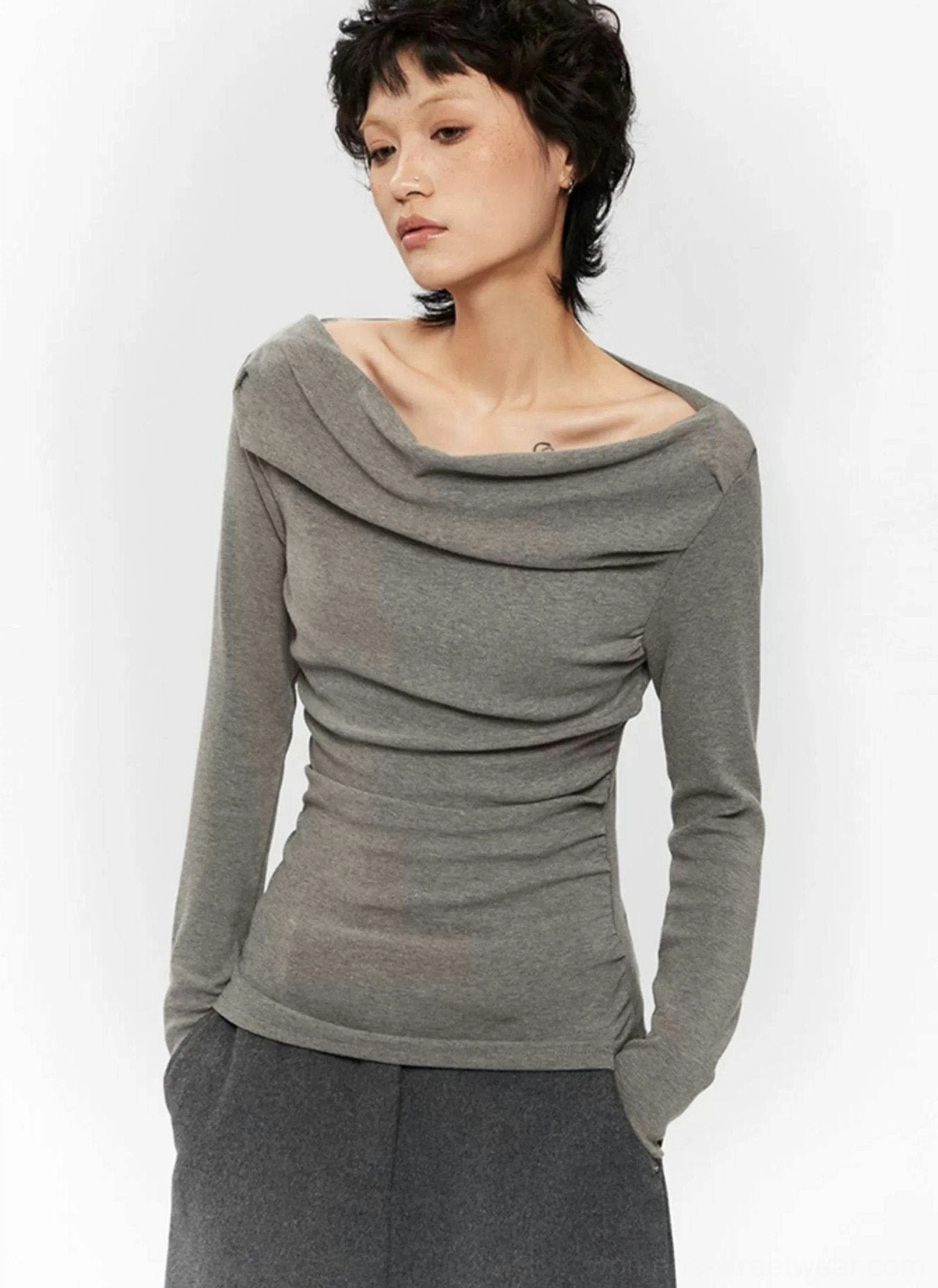 Grey fitted off-shoulder ruched top featuring a draped boat neckline, long sleeves, and contemporary Seoul streetwear aesthetic