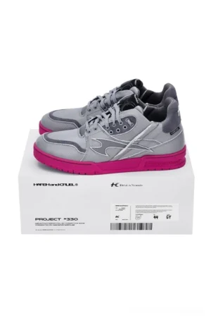 Pair of grey and hot pink low top sneakers viewed from above on shoe box showing lace-up design and vibrant pink sole