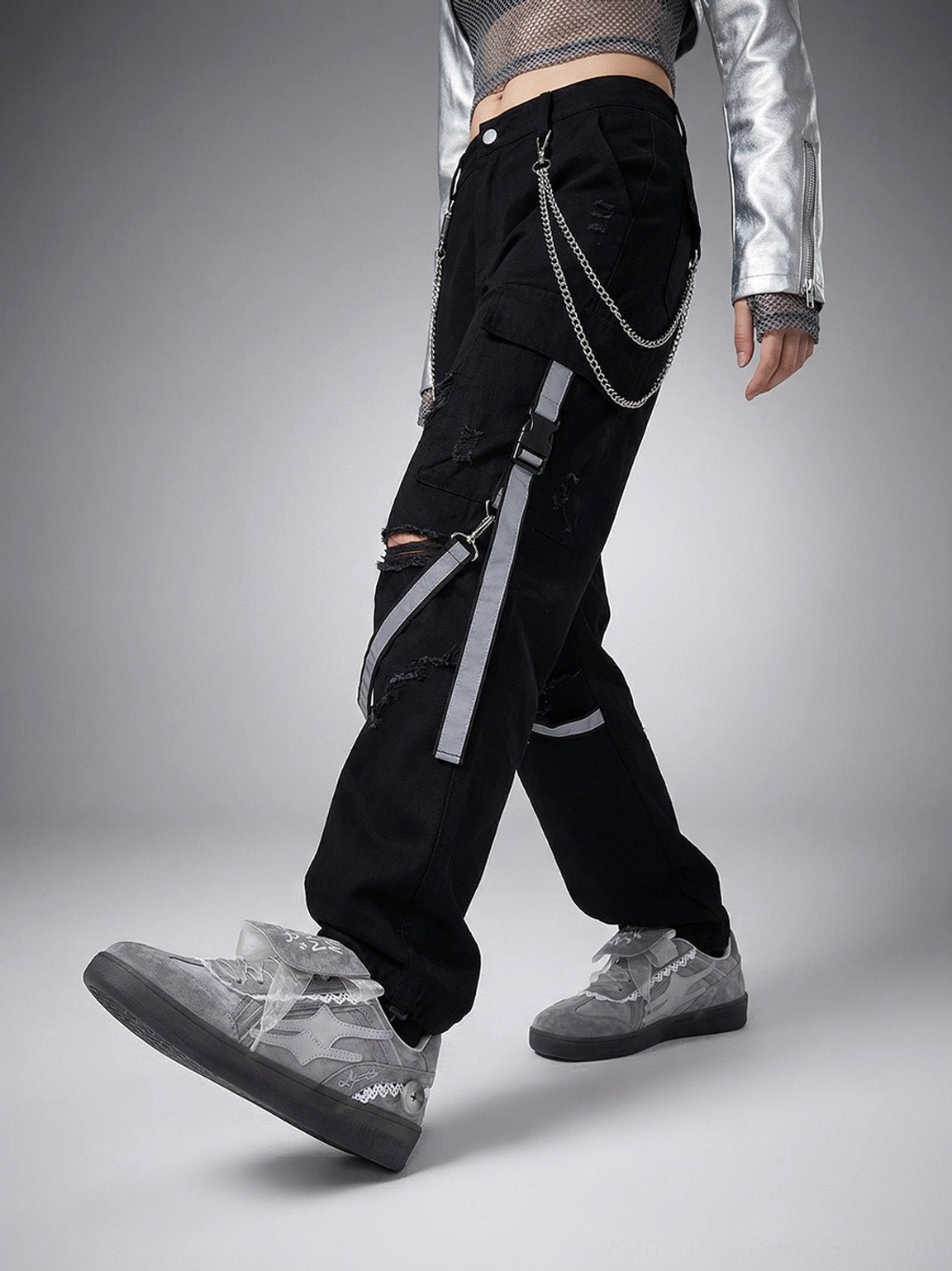 Grey lace-wrapped retro trainer sneakers styled with silver cropped jacket and black cargo pants