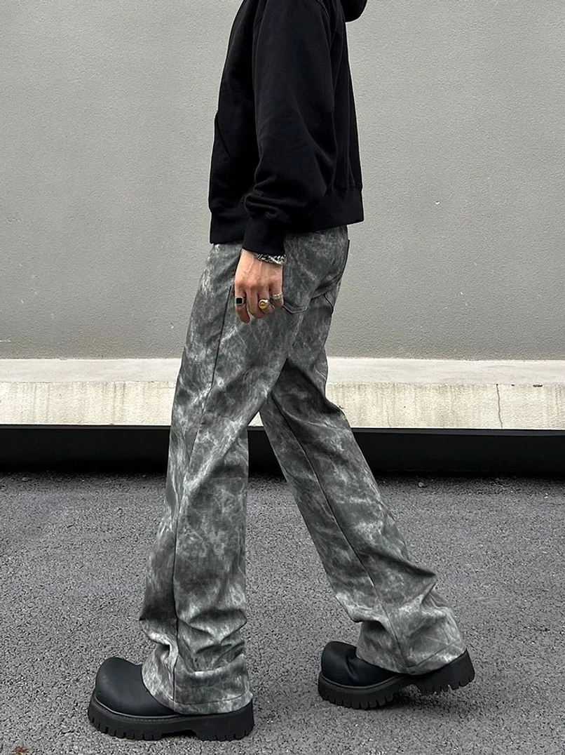 Side profile of grey marble wash relaxed flared streetwear jeans showing the loose leg fit, pocket detail, and wide hem