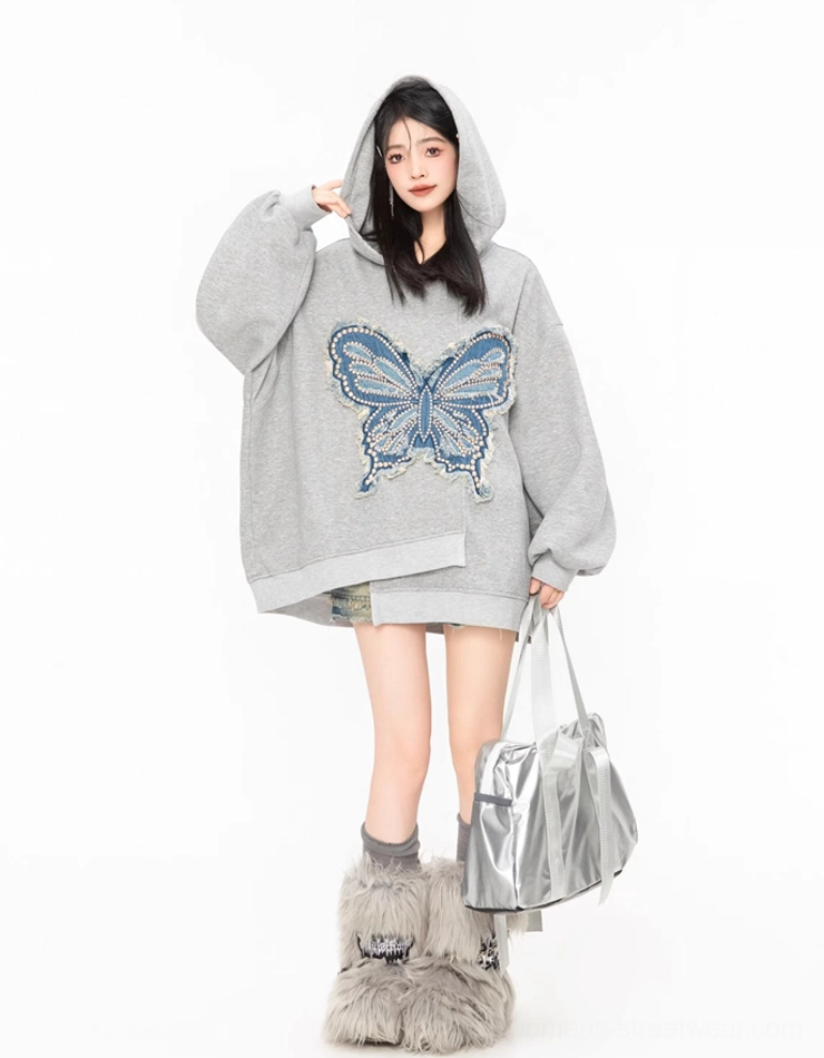 Full front view of a grey oversized butterfly hoodie with hood, dropped shoulders, long sleeves, and textured denim butterfly detail