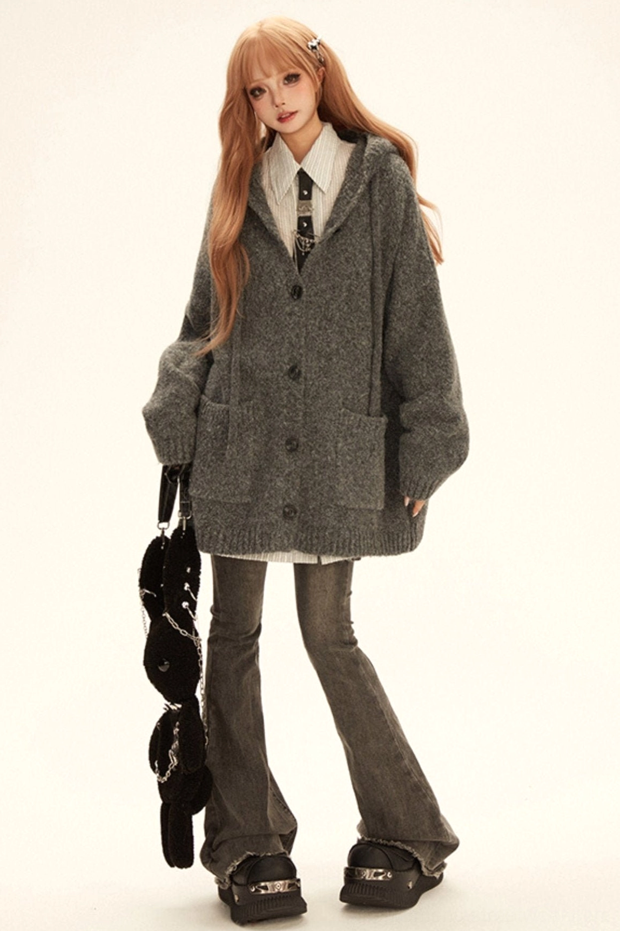 Front view of grey oversized hooded knit cardigan coat featuring long relaxed silhouette button closure and textured finish