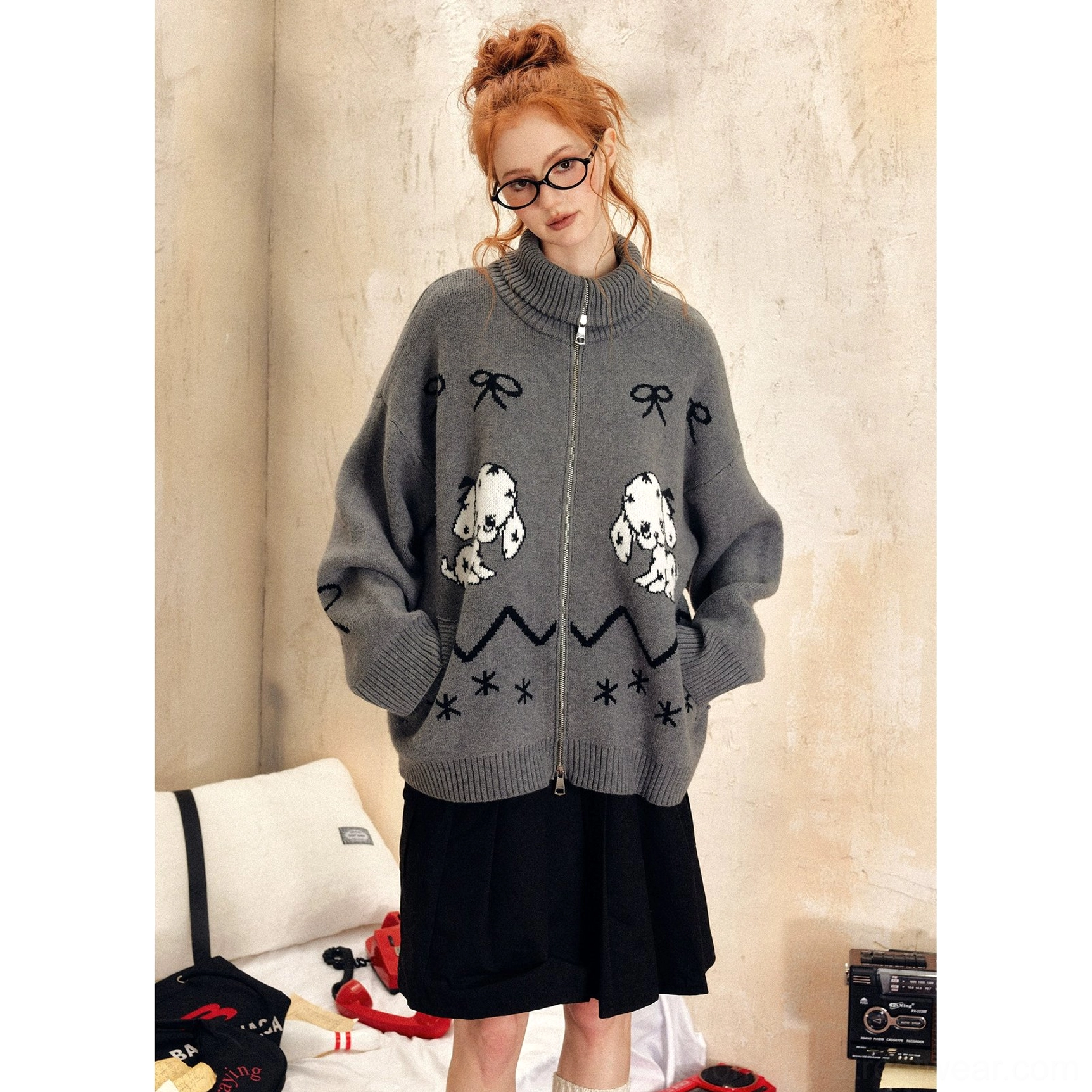 Grey oversized puppy print zip-up sweater with black bow and snowflake motifs, drop shoulders, and wide sleeves styled with black shorts