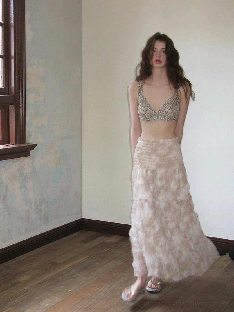 Close up view of grey floral lace halter neck top with delicate peony pattern and textured layered construction