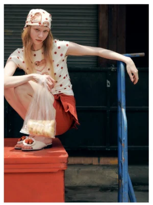 Side view of a fitted cropped heart cat polka dot T-shirt styled with a matching headscarf in a playful Y2K streetwear outfit