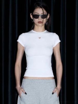 White slim ribbed short sleeve heart detail tee styled with grey sweatpants in a front full body studio view