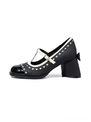 Black and white heart stud square-toe block-heel Mary Jane shoes with T-strap and gold buckle shown in a three-quarter product view