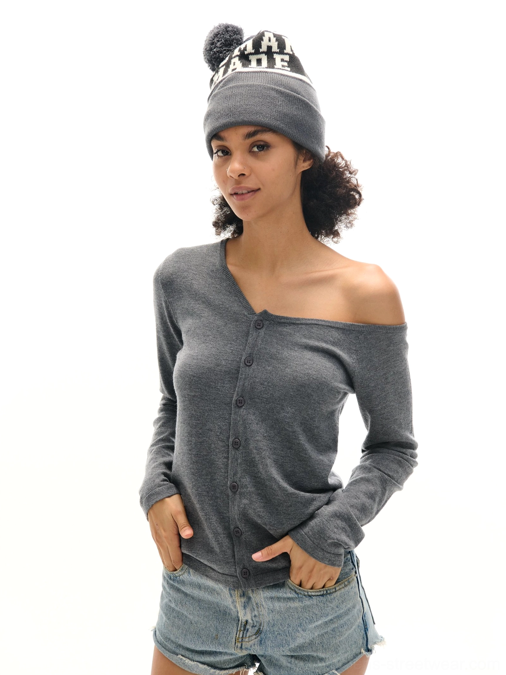 Heather gray asymmetrical off-shoulder button-front knit cardigan styled with denim shorts and a streetwear beanie