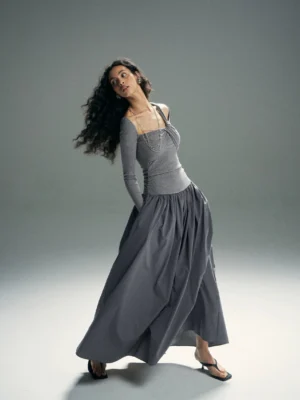 Heather gray asymmetrical twist cold-shoulder maxi dress shown in a low-angle full-body studio view with a ruched waist, long sleeves, and flowing floor-length skirt