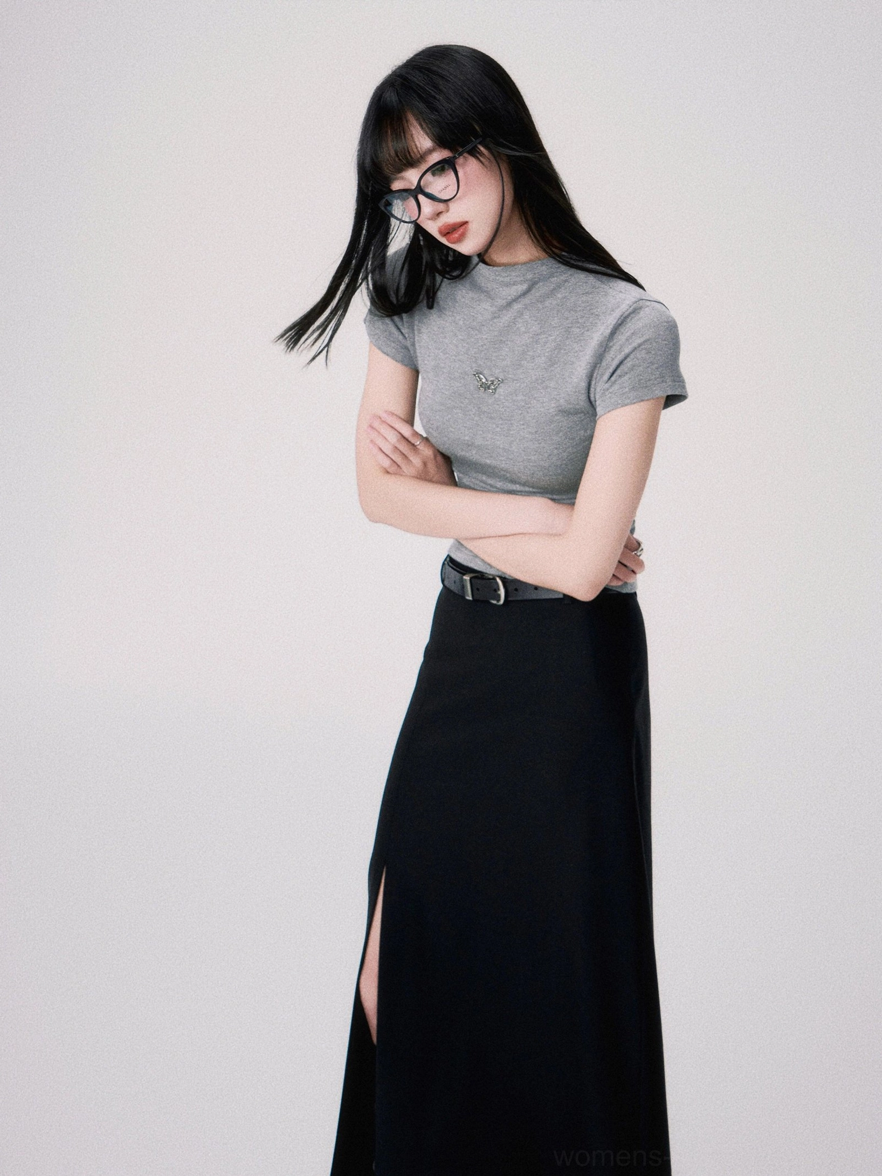 Side front view of a heather gray butterfly embroidered fitted crop tee with a defined waist