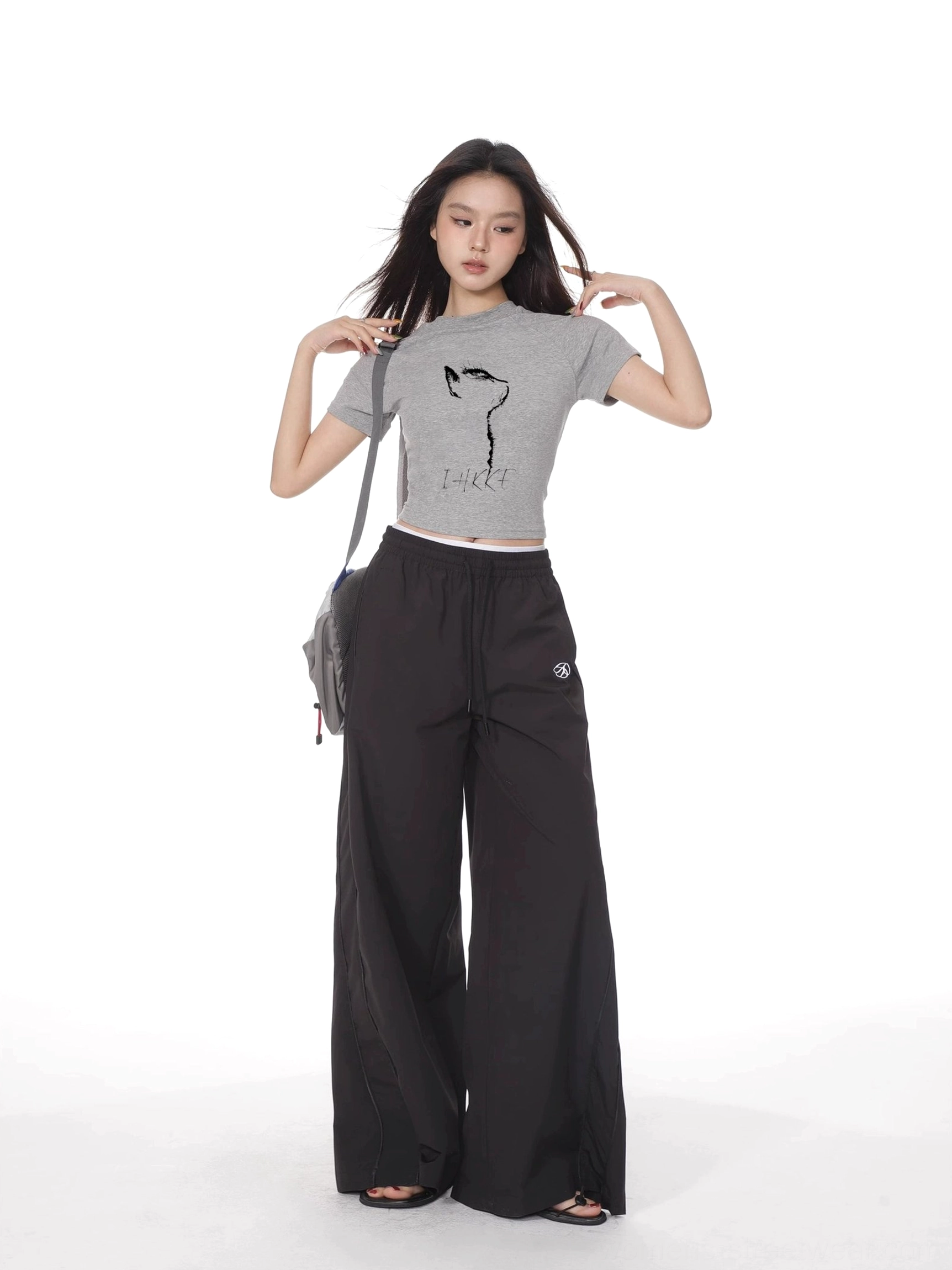 Heather gray cat print cropped fitted short sleeve t-shirt styled with black wide leg trousers and gray crossbody bag