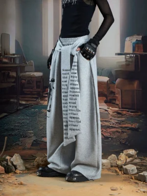 Heather gray draped panel graphic wide-leg streetwear joggers with text print waist panel side front view