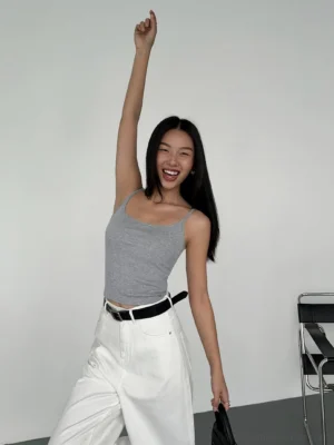 Heather gray fitted cami crop top styled with high-waisted white wide-leg pants and a black belt