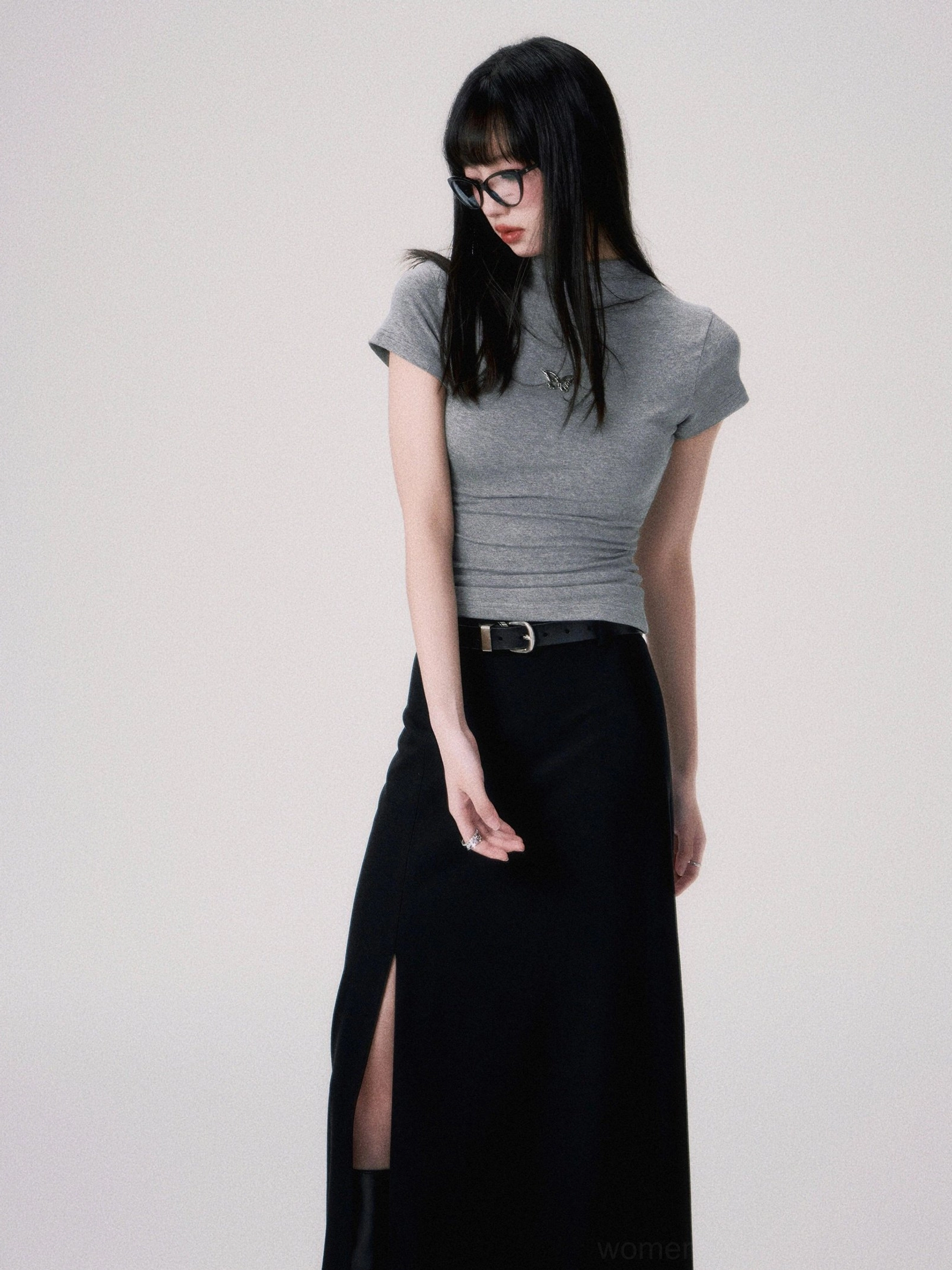 Close side view of a heather gray fitted crop tee featuring delicate butterfly chest embroidery