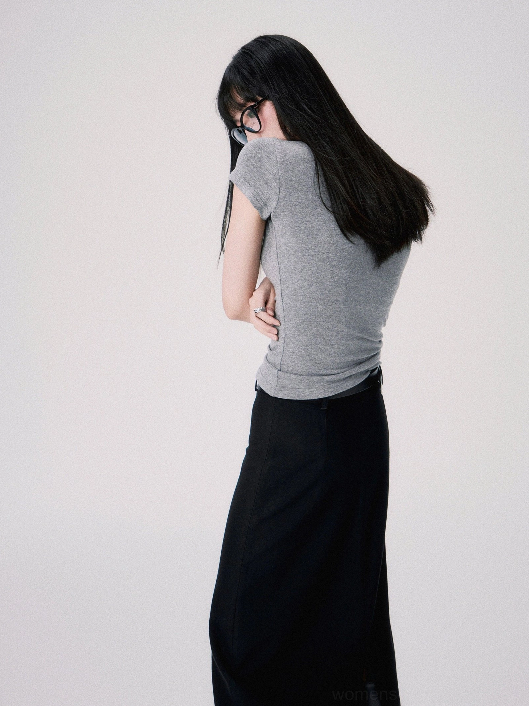 Back view of a heather gray fitted cropped short sleeve tee with a streamlined streetwear silhouette