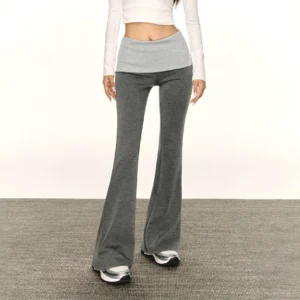Heather gray layered waistband flare leggings styled with a white cropped long sleeve top and silver black casual sneakers in a modern streetwear outfit