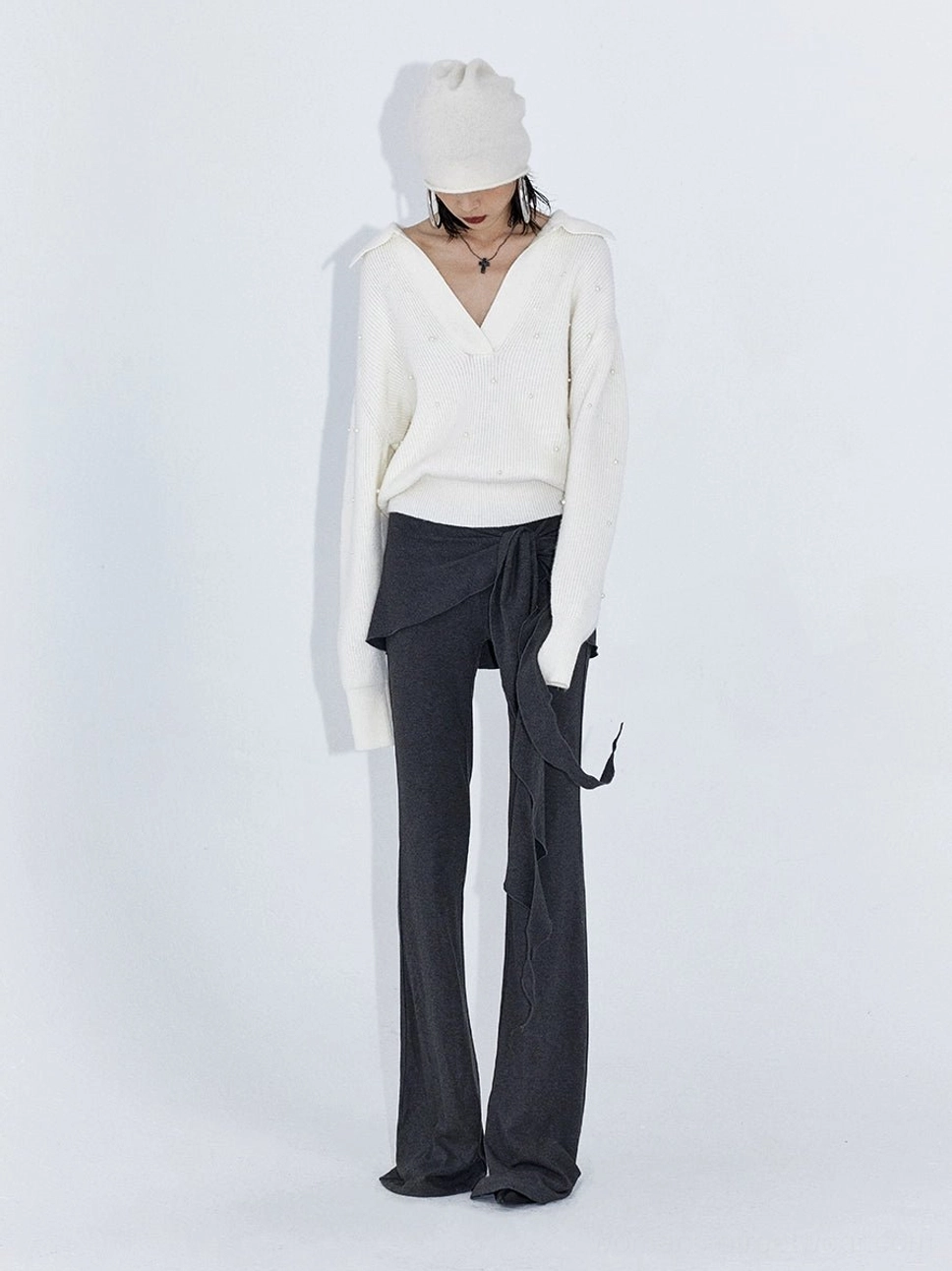 Heather gray low rise wrap drape flare streetwear pants styled with a white V neck top and white beanie