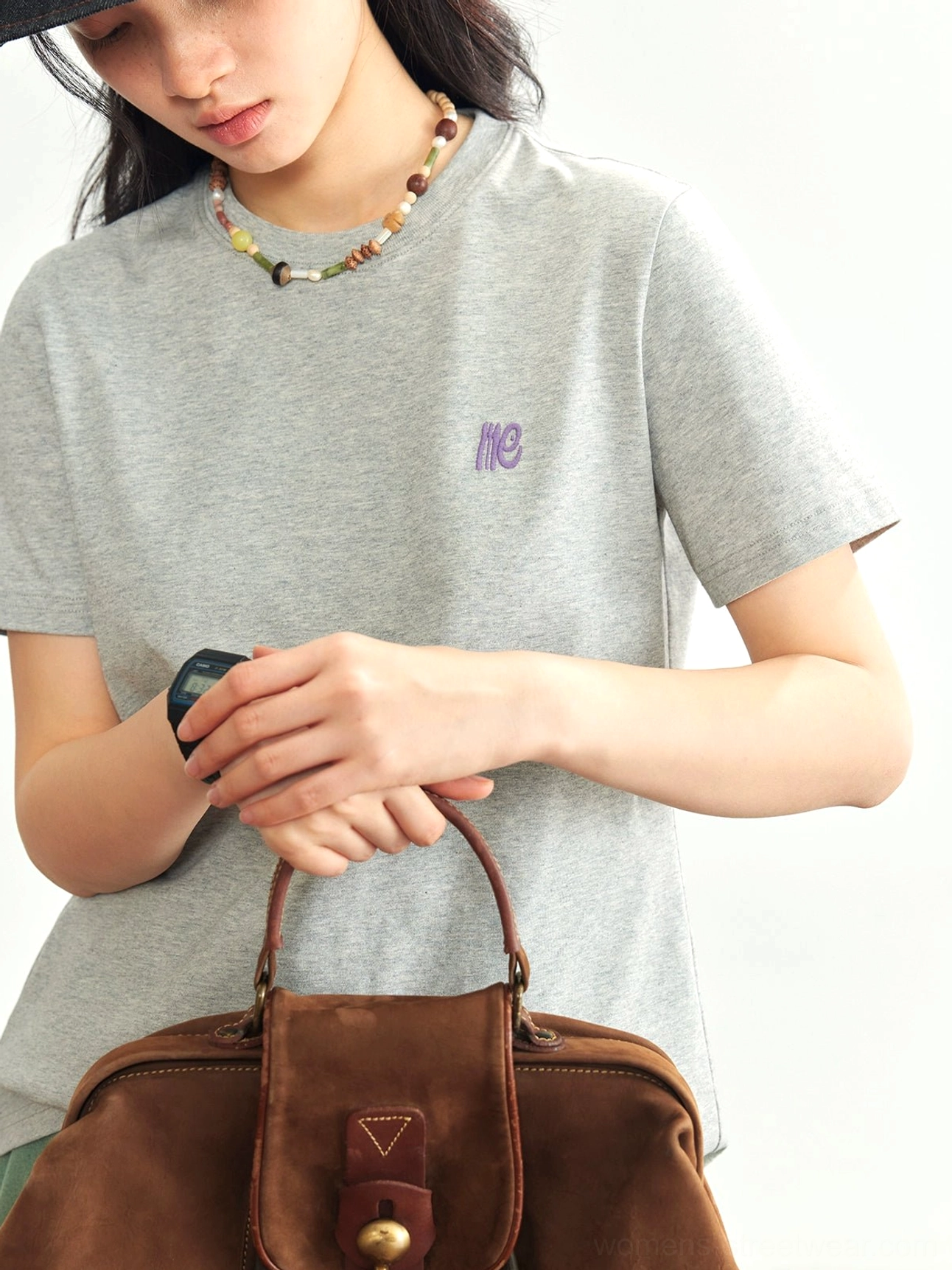 Heather gray minimalist embroidered logo crew neck tee upper body close-up leather tote bag streetwear