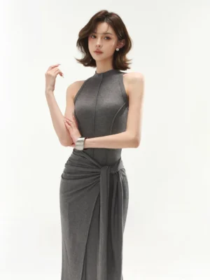 Close front view of heather gray sleeveless mock neck maxi dress featuring structured bodice seams and a wrap inspired tie waist