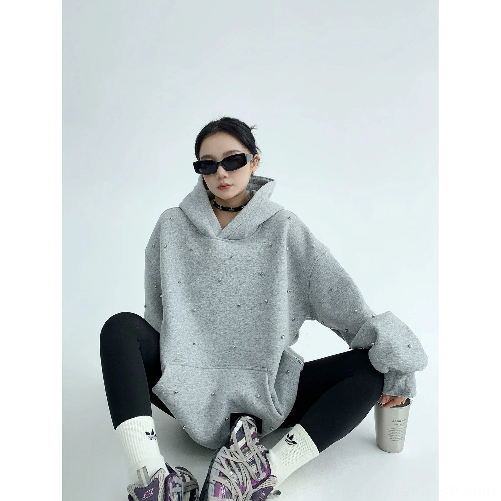 Heather gray pearl-studded oversized hoodie with an extra-large hood, wide sleeves, and decorated front pocket in a streetwear outfit