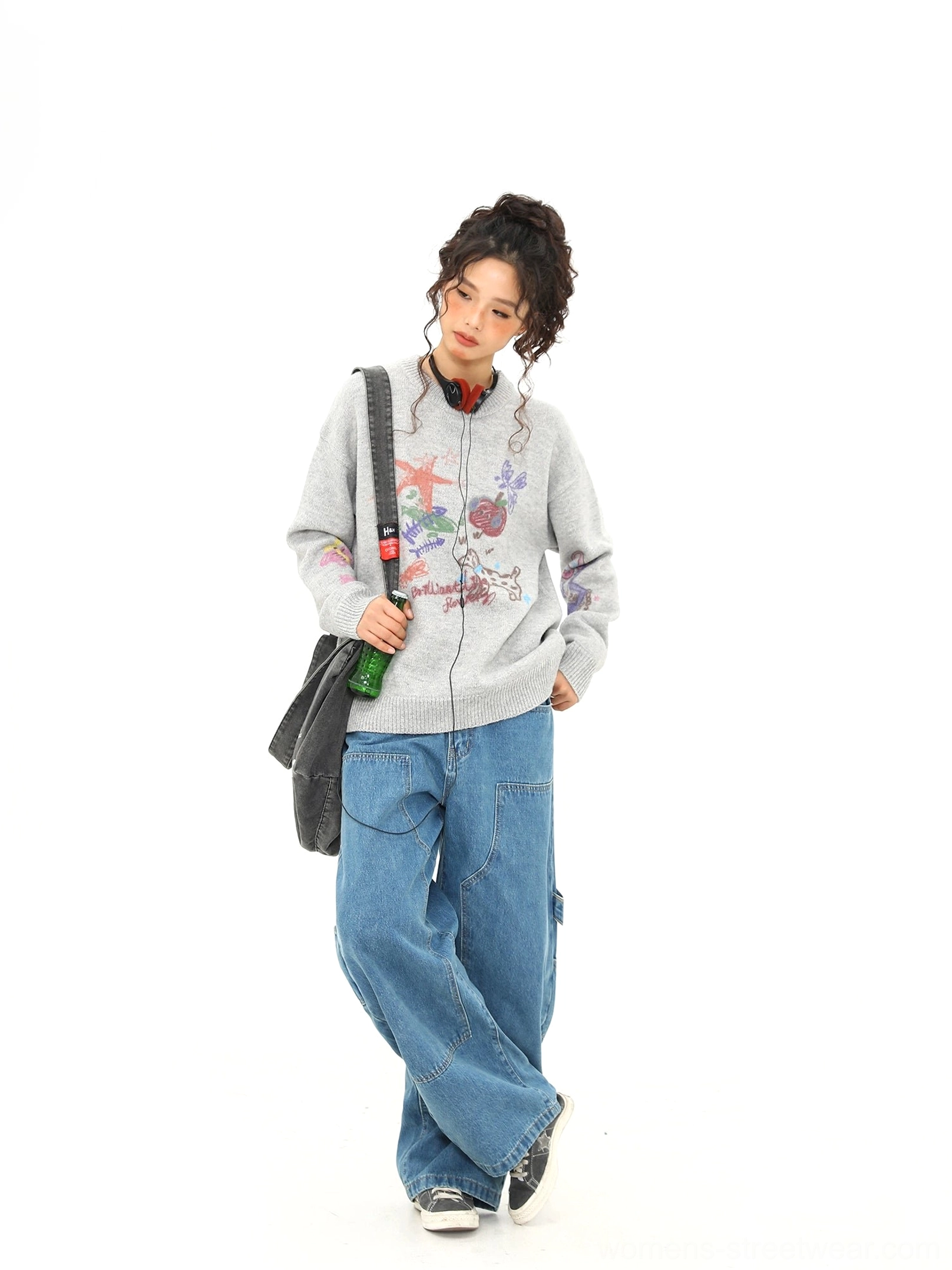 Side three-quarter view of relaxed heather gray graphic knit sweater with playful puppy doodle streetwear artwork