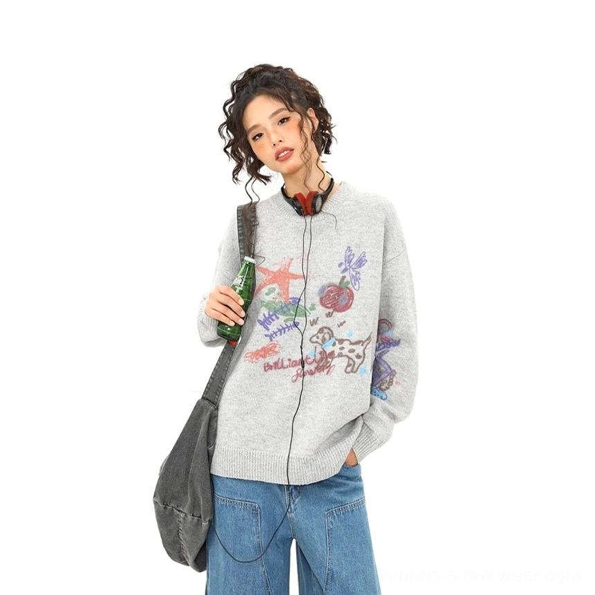 Three-quarter front view of heather gray oversized puppy doodle knit sweater with all-over colorful cartoon artwork