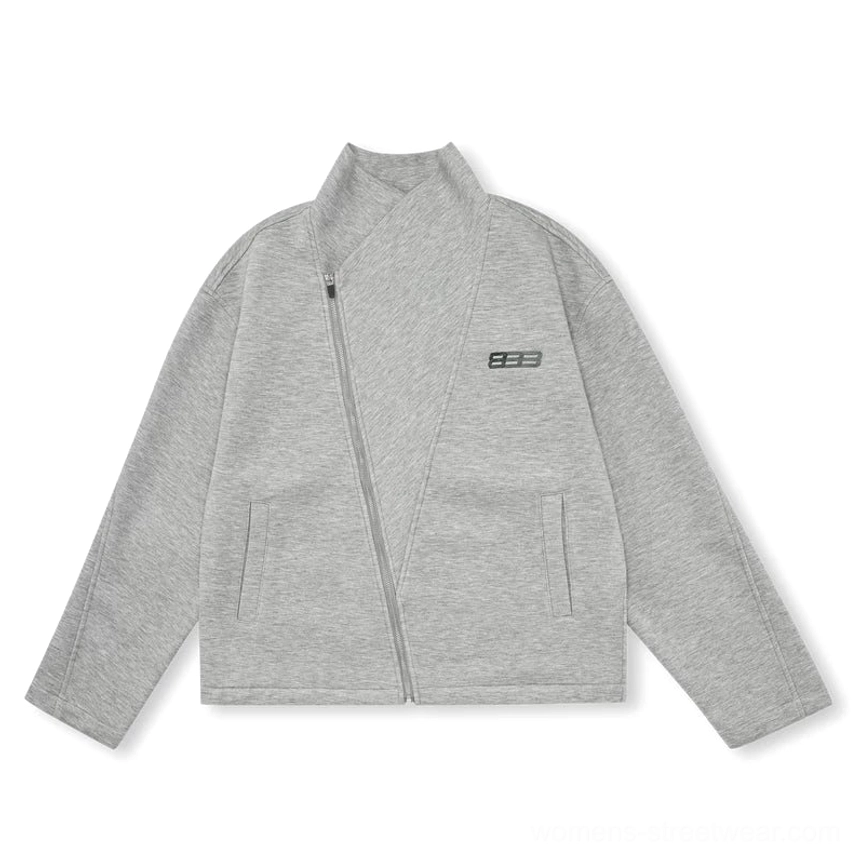 Heather gray relaxed unisex asymmetric zip jacket flat lay with high collar, stretch-knit shell, side insert pockets, and metal chest detail