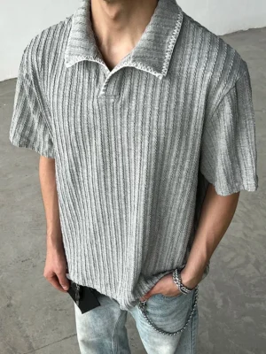 Heather gray ribbed knit streetwear polo shirt close-up with vertical textured knit and contrast stitched collar