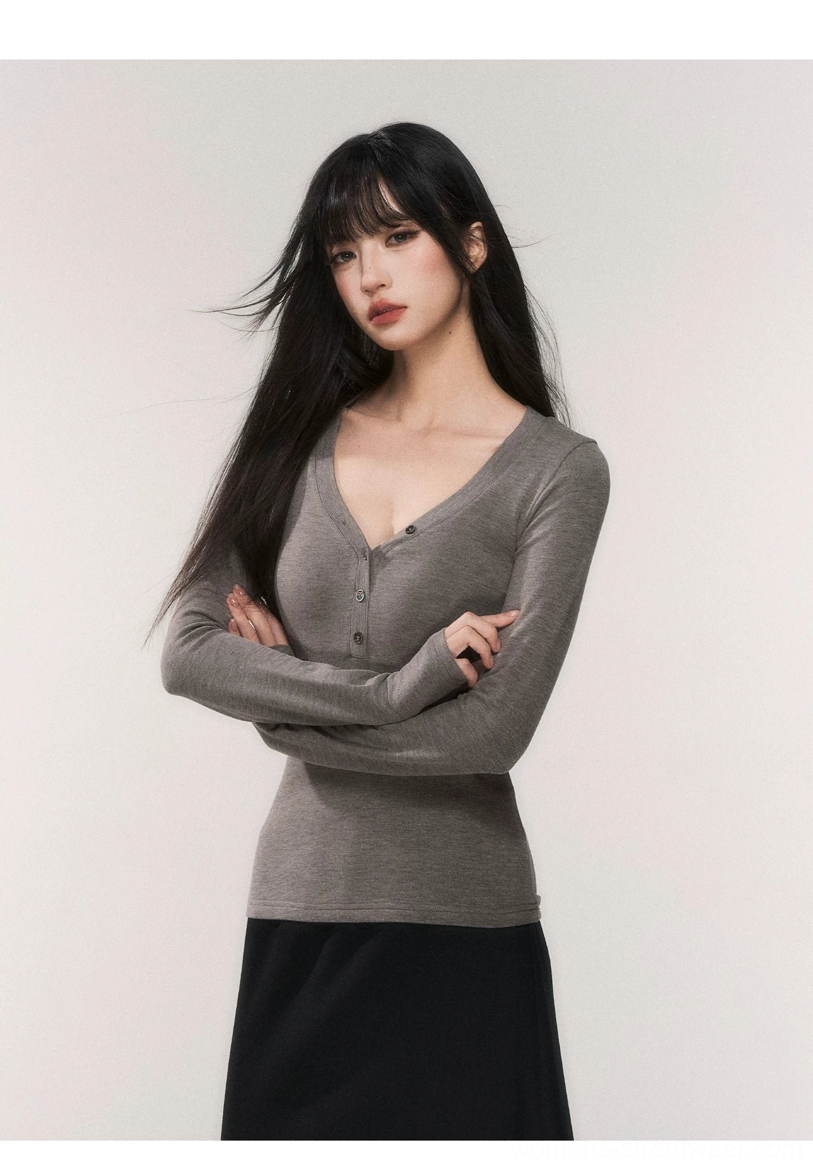 Heather gray fitted V-neck henley long sleeve knit top paired with a black maxi skirt in minimalist streetwear styling