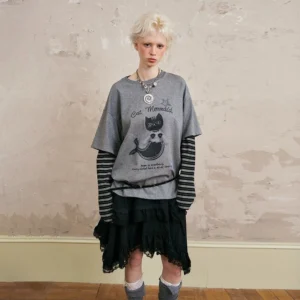Heather gray vintage graphic layered tee with striped sleeves and cat mermaid print styled with a leather waist belt