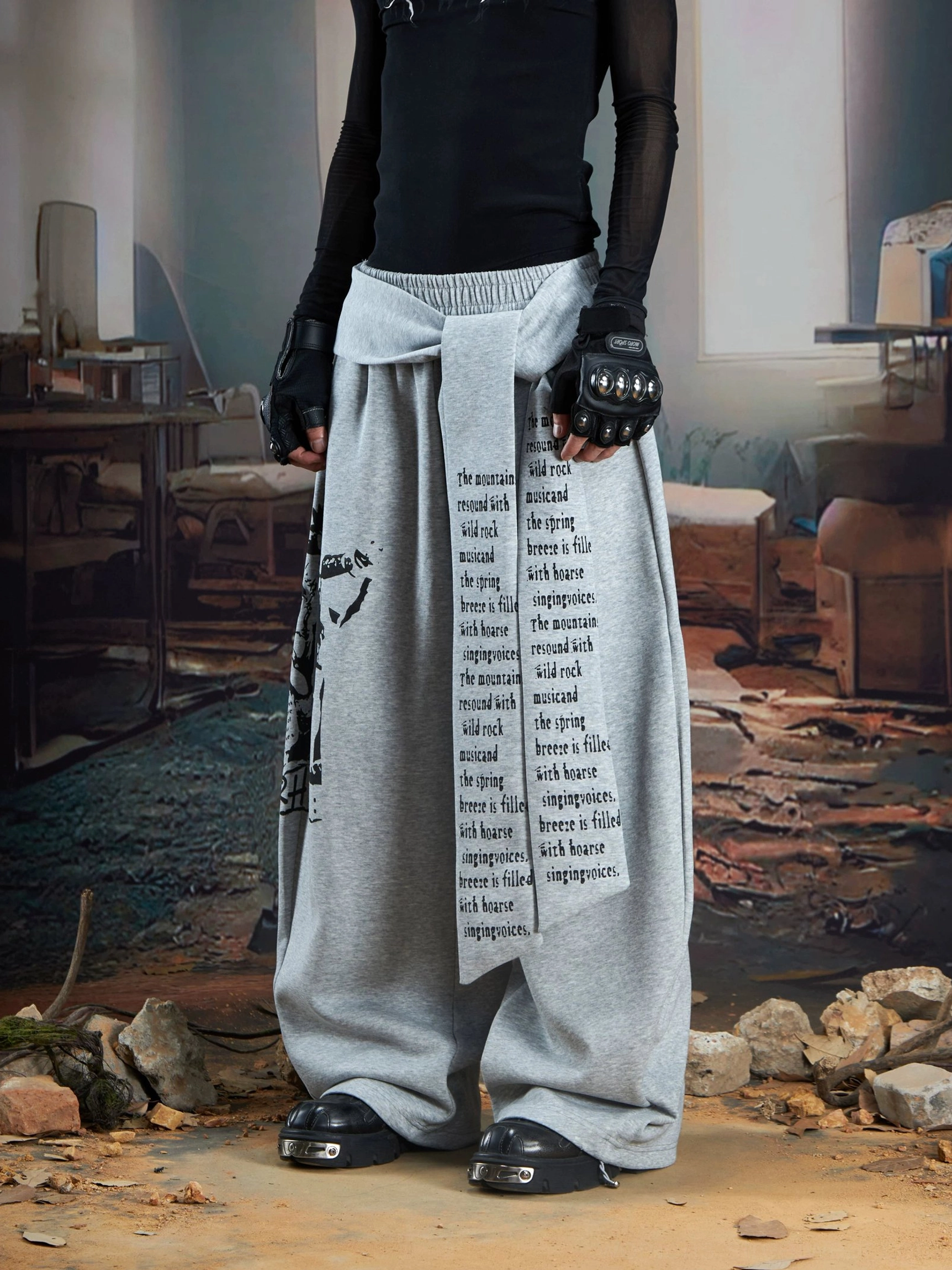 Heather gray wide-leg streetwear joggers with long draped text panel and oversized baggy fit