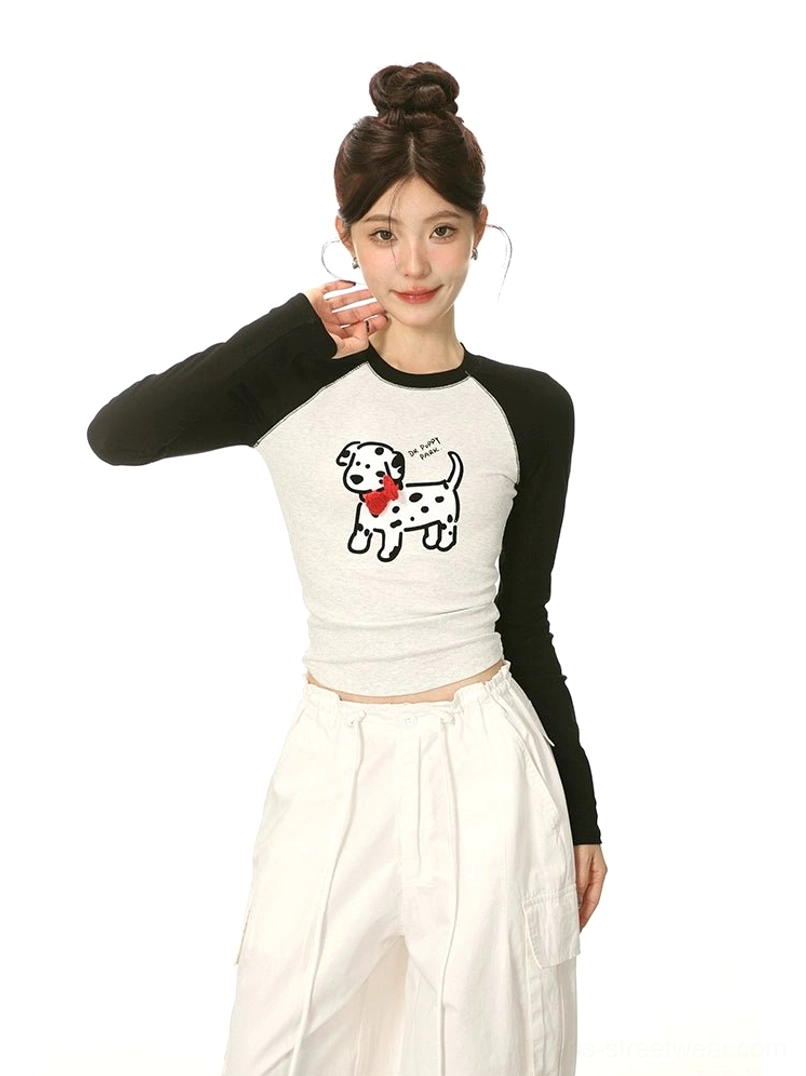 Close-up view of heather grey and black cartoon Dalmatian cropped streetwear top with red bow graphic and fitted silhouette