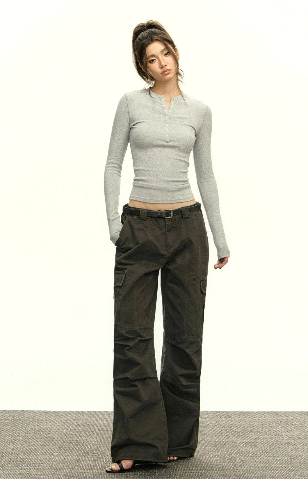 Heather grey ribbed Henley long-sleeve crop top paired with dark wide-leg trousers and black belt