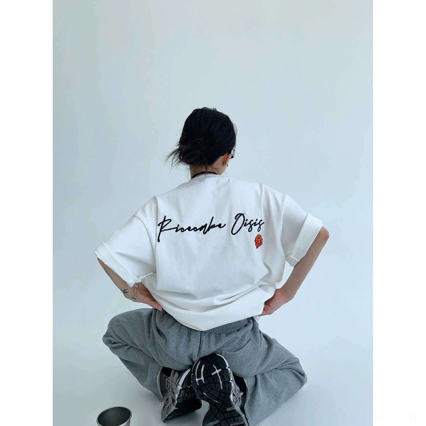 Heavyweight oversized neon script streetwear T-shirt featuring bold pink cursive back lettering and a small contrasting emblem