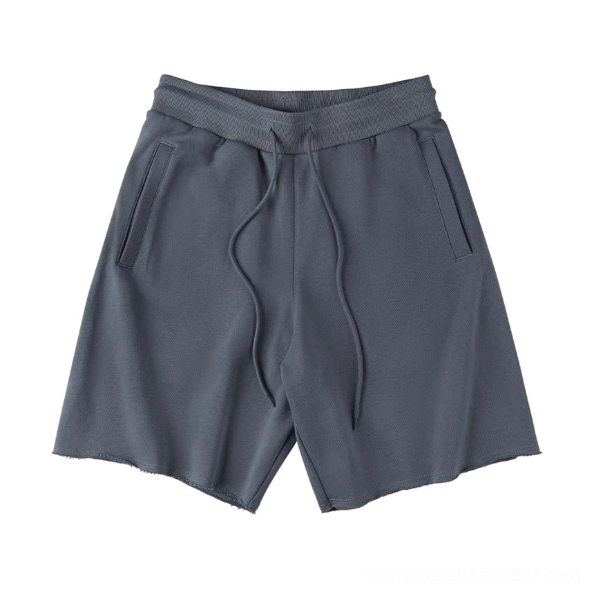 Dark charcoal heavyweight drawstring sweat shorts showing raw frayed hem and adjustable waist