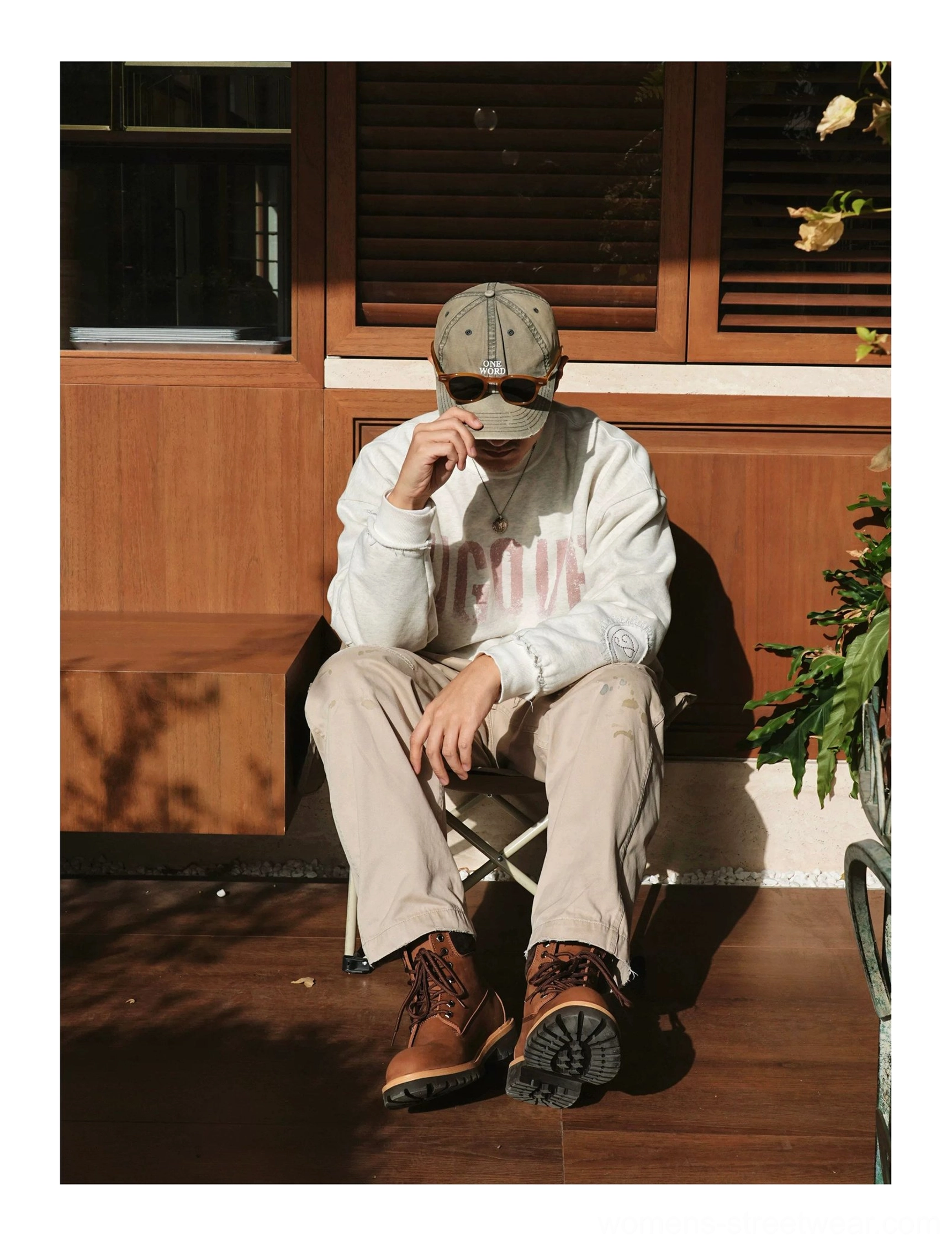 Heritage leather work boots worn with cargo pants and printed sweatshirt in a casual outdoor streetwear outfit