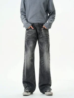 High-rise charcoal black washed jeans with zipper closure styled with a grey sweatshirt and casual sneakers