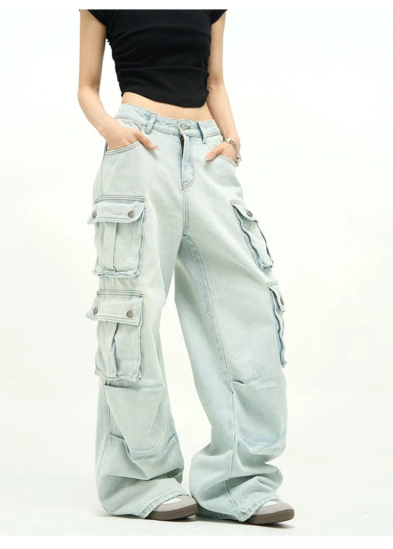 Front view of high-rise light blue cargo jeans with button-secured flap pockets, oversized legs, and modern Y2K streetwear styling
