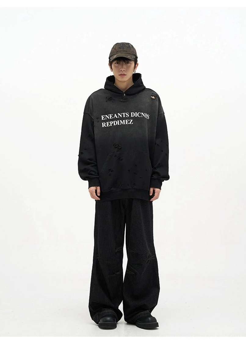 Front view of black baggy denim jeans with relaxed wide leg fit paired with a distressed hoodie for urban streetwear styling