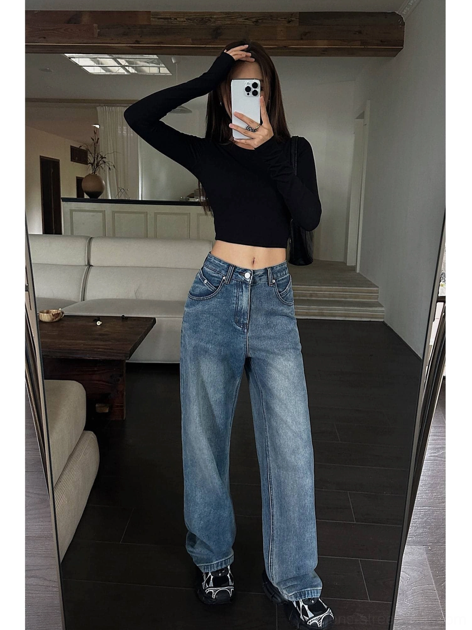 Mirror selfie styling of high-waist blue wide-leg denim jeans with button closure and a black cropped top