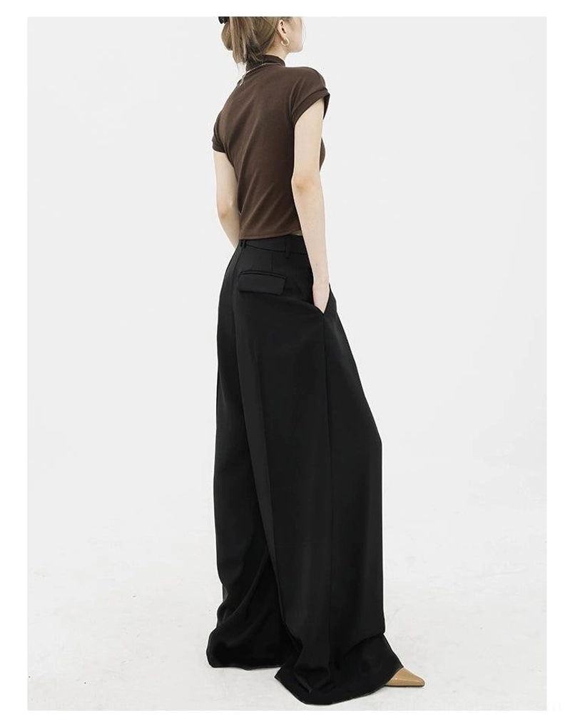 Black wide-leg palazzo pants rear view showing back pocket detail and flowing streetwear fit