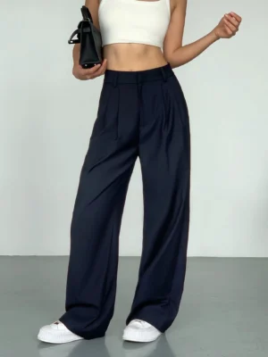 Deep navy high-waist wide-leg streetwear suit trousers with front pleats styled with a white cropped tank top