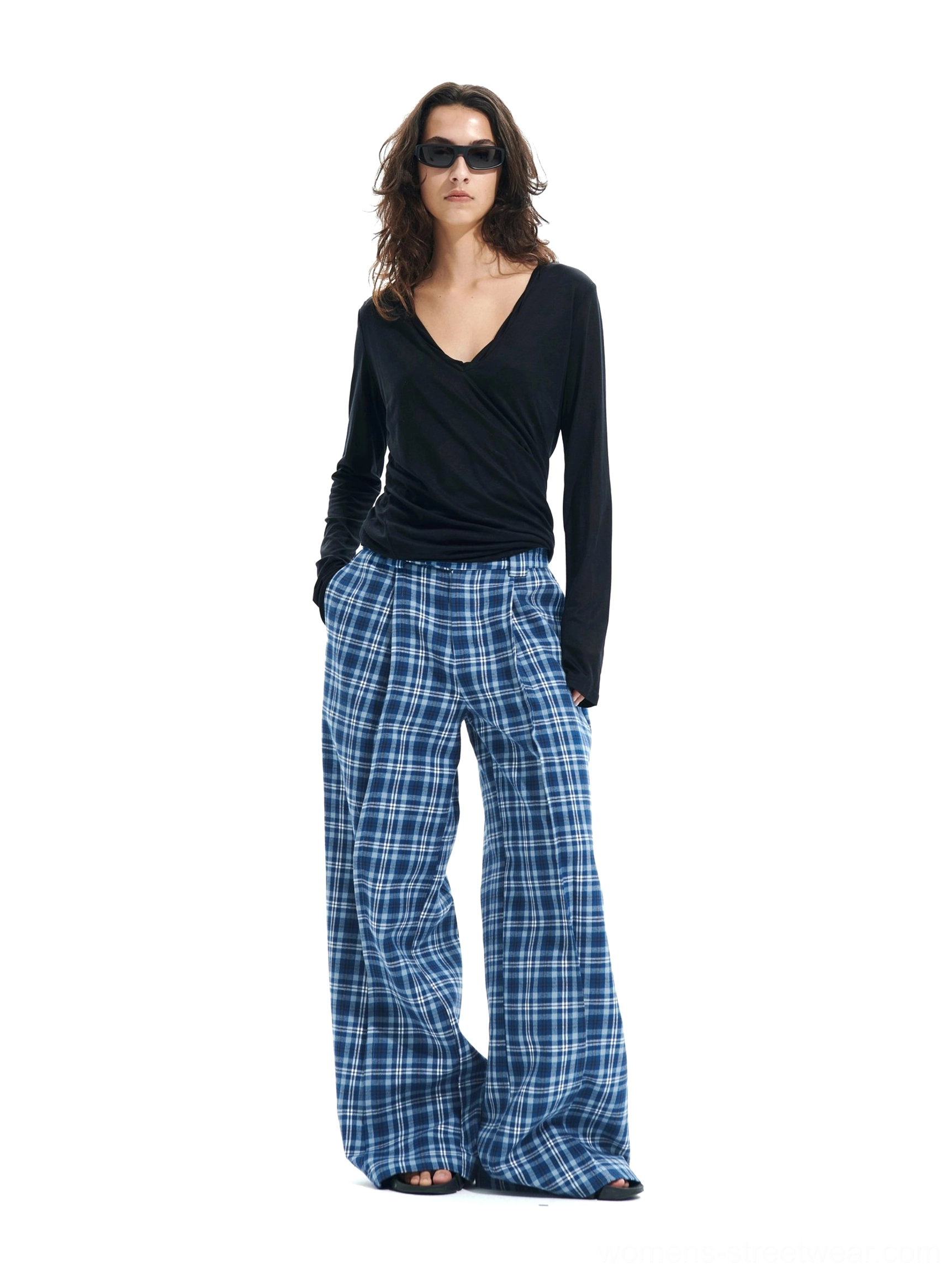 Front view of high-waisted blue plaid wide-leg trousers with front pleats and floor-length streetwear styling