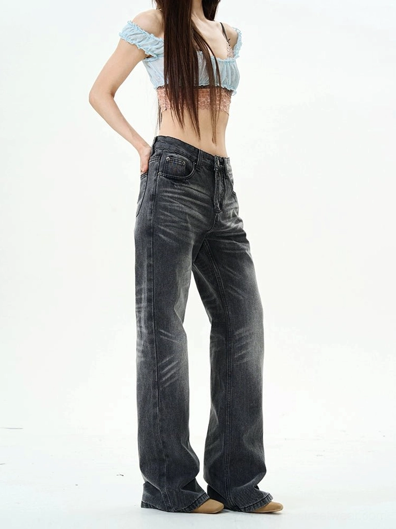 Side view of high-waisted charcoal washed straight leg jeans styled with a cropped lace camisole